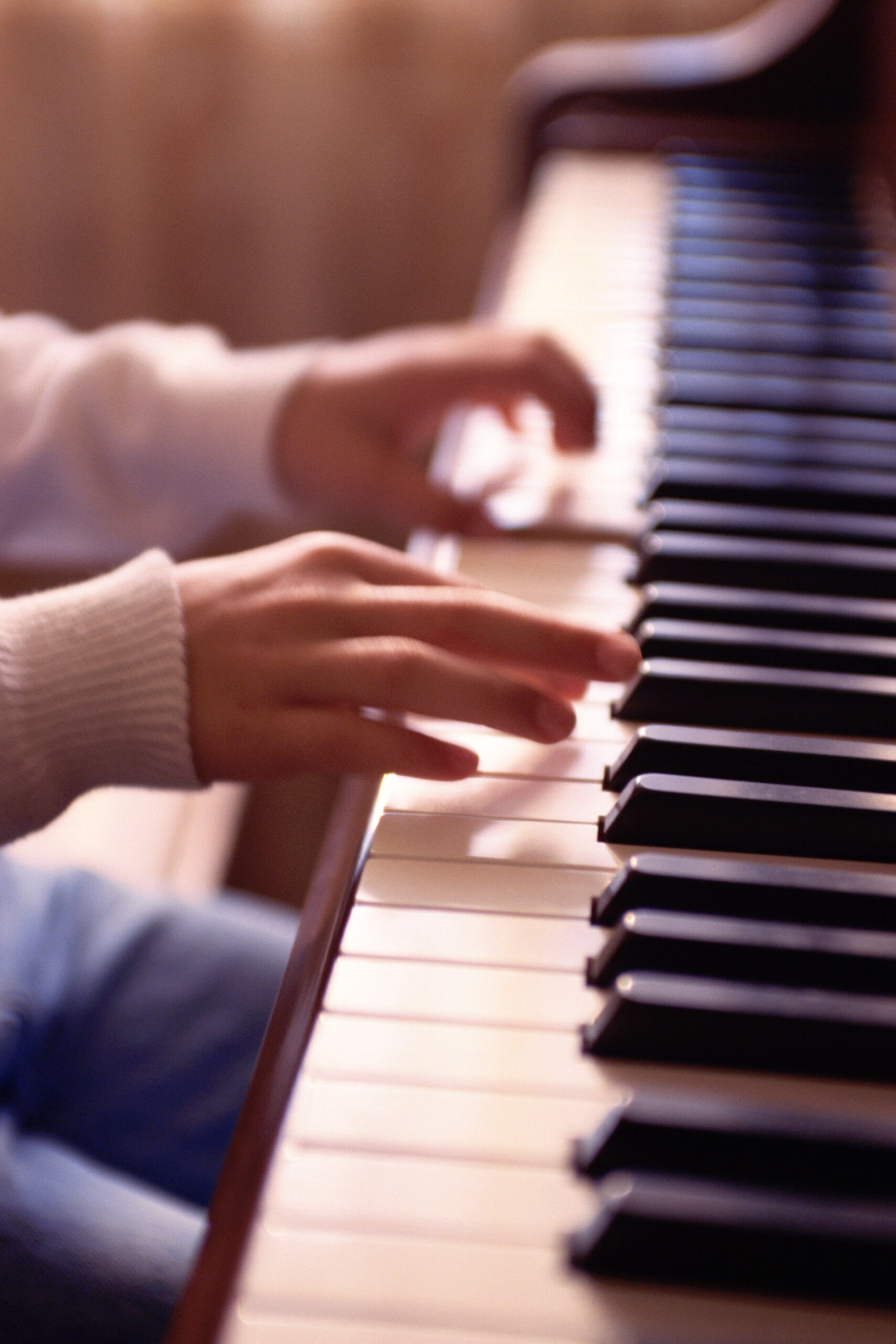 Hands of child playing piano